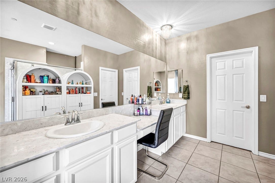 Clean lines and a spacious dual vanity define this bright bathroom space.