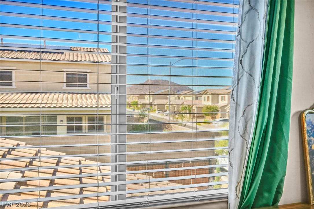 Scenic neighborhood and mountain vistas unfold through the window.