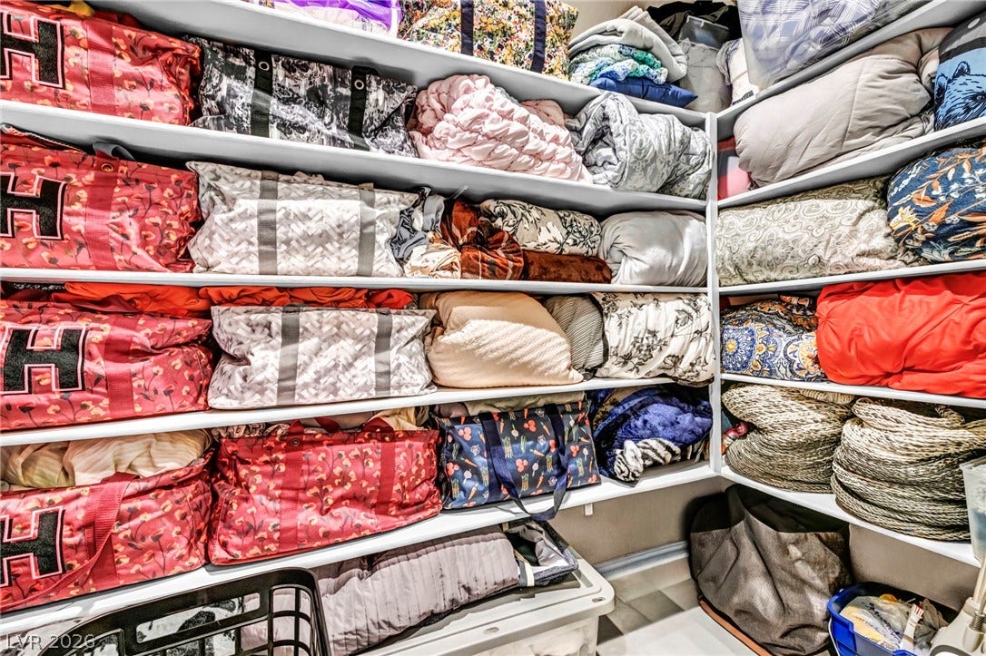 Ample built-in shelving provides generous storage capacity inside this walk-in closet.