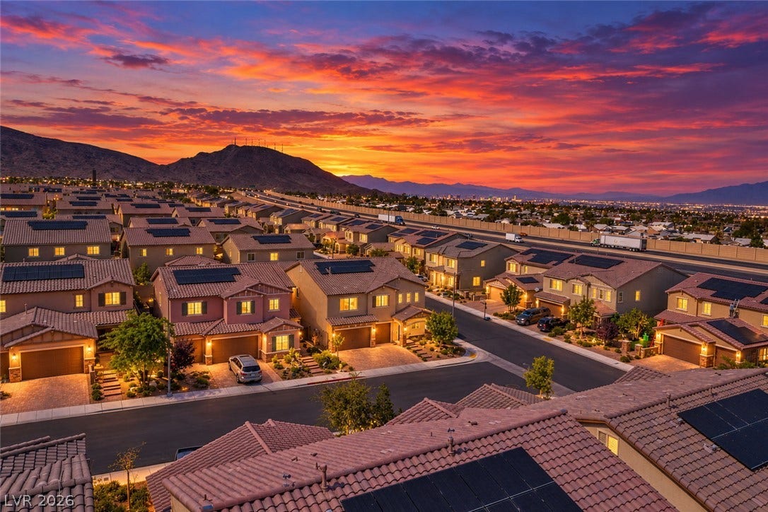 Dramatic sunset views frame this modern hillside neighborhood showcasing solar-equipped tile roofs.