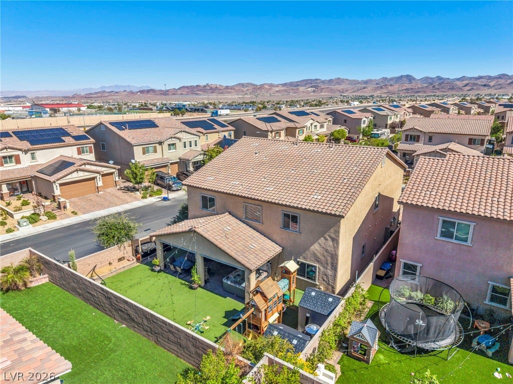 A spacious backyard enjoys majestic mountain views from its neighborhood setting.