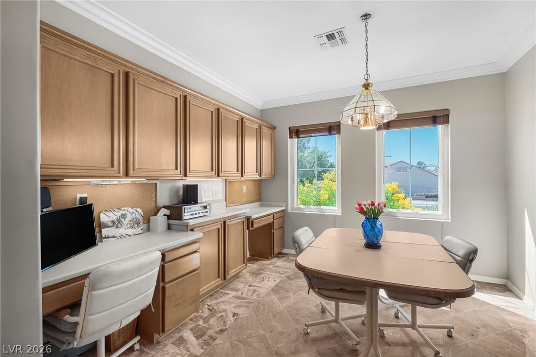 2738 Grand Forks Road, Henderson, NV 89052 Generous natural light streams across the tiled flooring and built-in cabinetry of this versatile workspace.