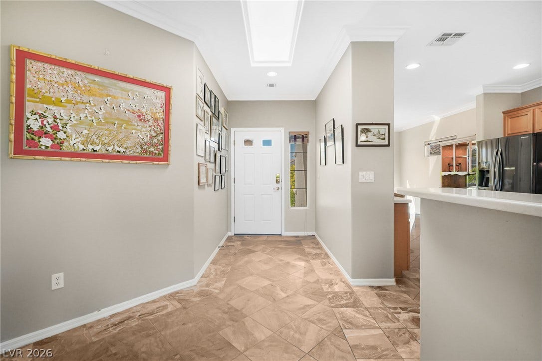 2738 Grand Forks Road, Henderson, NV 89052 An inviting entrance foyer welcomes guests with elegant crown molding and classic tile flooring.