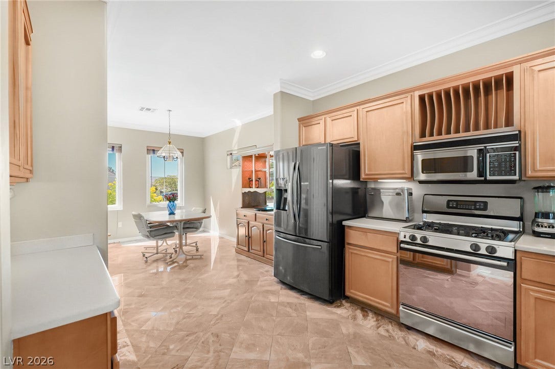 2738 Grand Forks Road, Henderson, NV 89052 Polished tile flooring flows from the kitchen into a sunlit dining area.