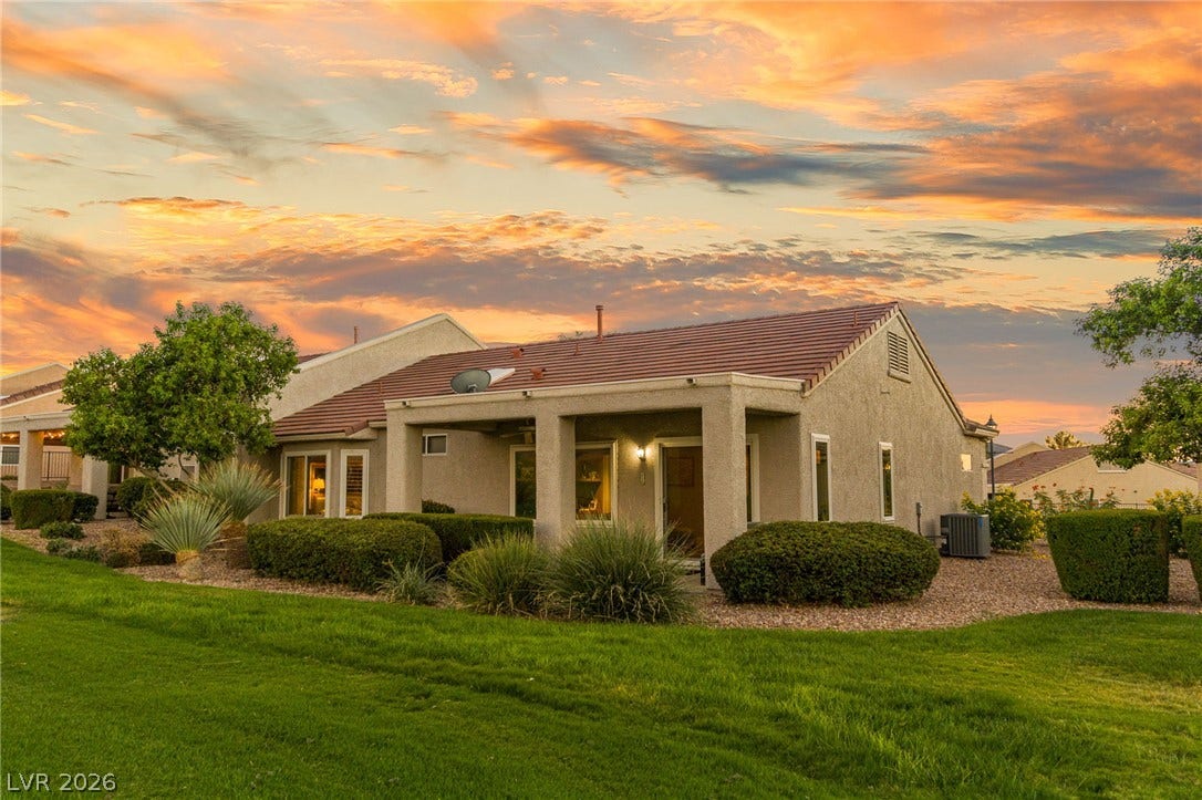 2738 Grand Forks Road, Henderson, NV 89052 Manicured green lawns frame this desert home featuring a covered patio and tile roof.