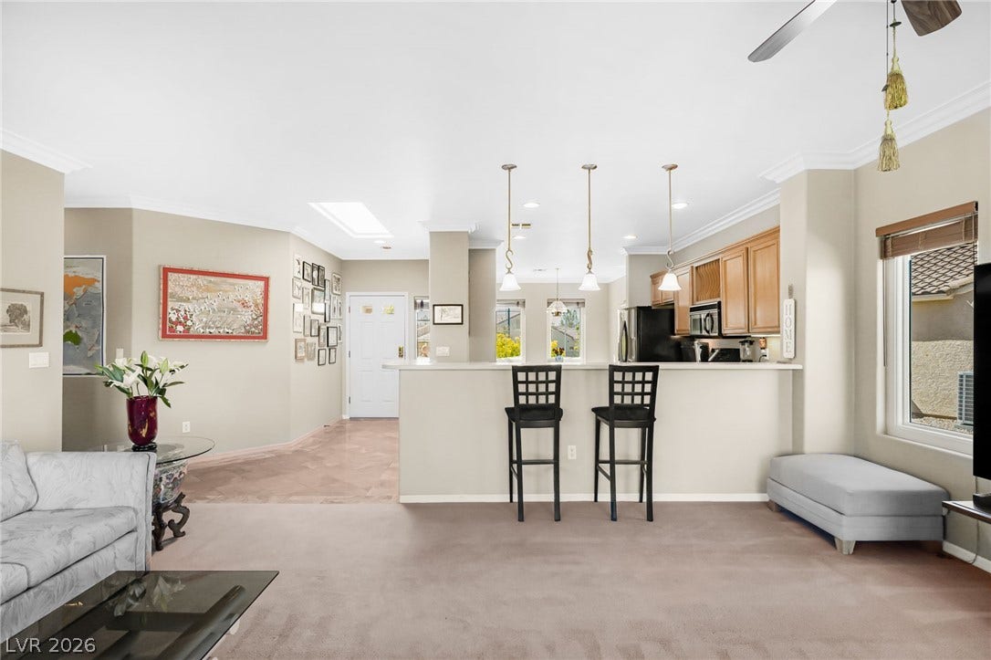 2738 Grand Forks Road, Henderson, NV 89052 Crisp crown molding framing a fluid open layout connects the living and kitchen spaces.