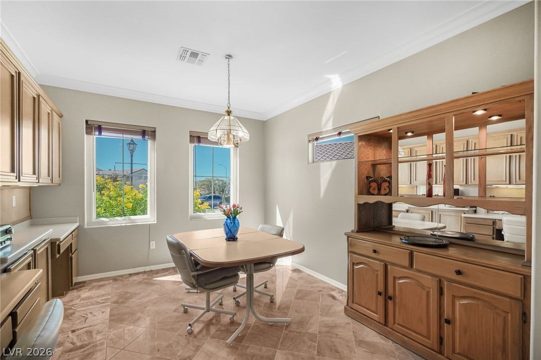 2738 Grand Forks Road, Henderson, NV 89052 Tile flooring and classic crown molding define this versatile dining space.
