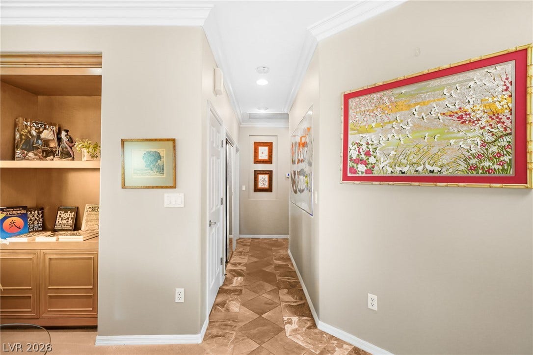 2738 Grand Forks Road, Henderson, NV 89052 Gleaming tile floors and elegant crown molding define this welcoming hallway space.