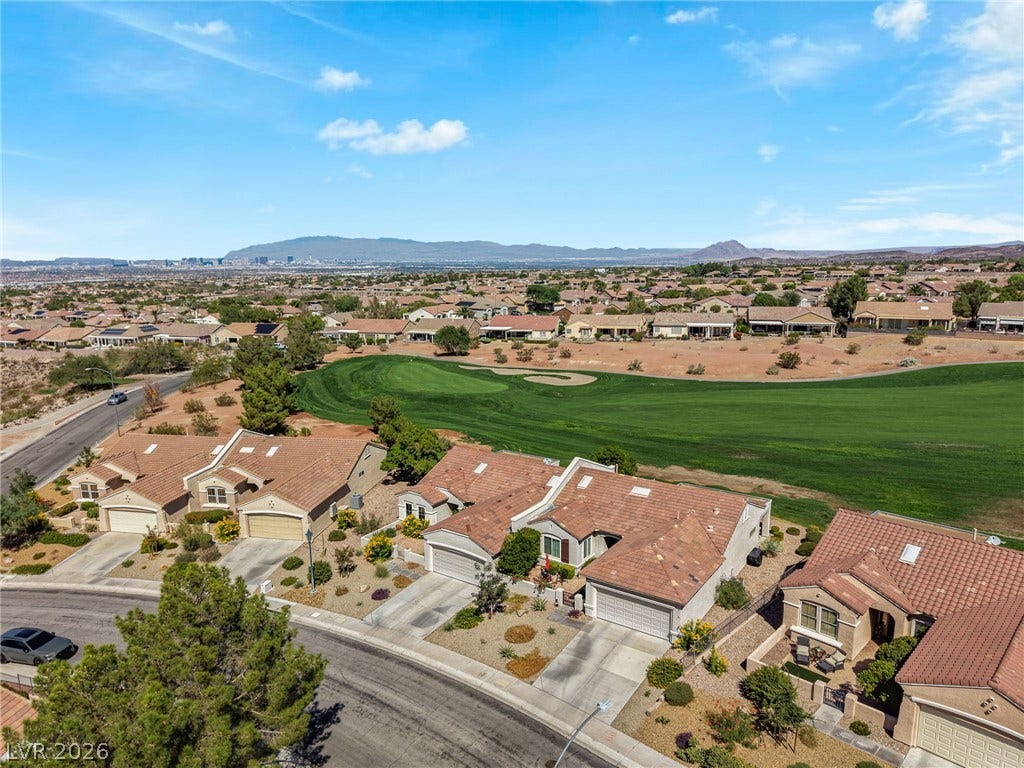 2738 Grand Forks Road, Henderson, NV 89052 An aerial perspective captures elegant tile-roofed residences bordering a lush green golf course.