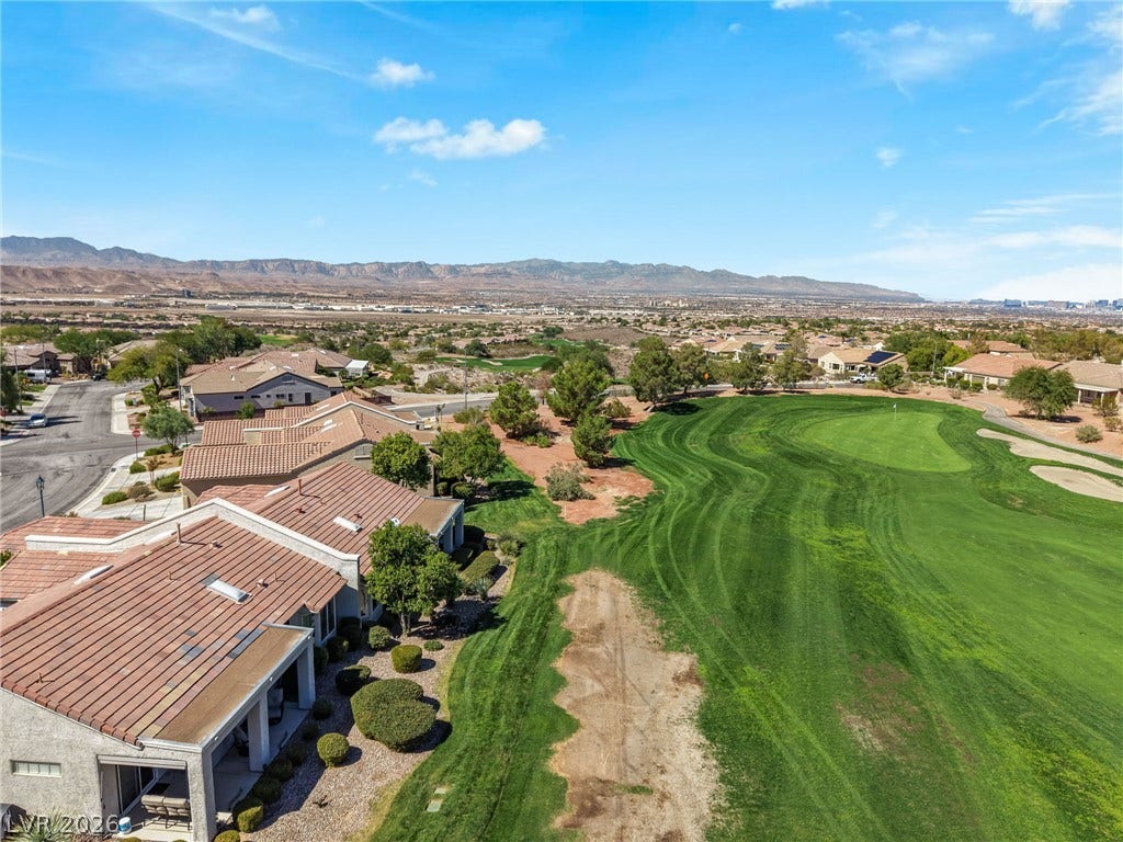 2738 Grand Forks Road, Henderson, NV 89052 Lush fairways stretch toward distant mountain horizons under expansive desert skies.