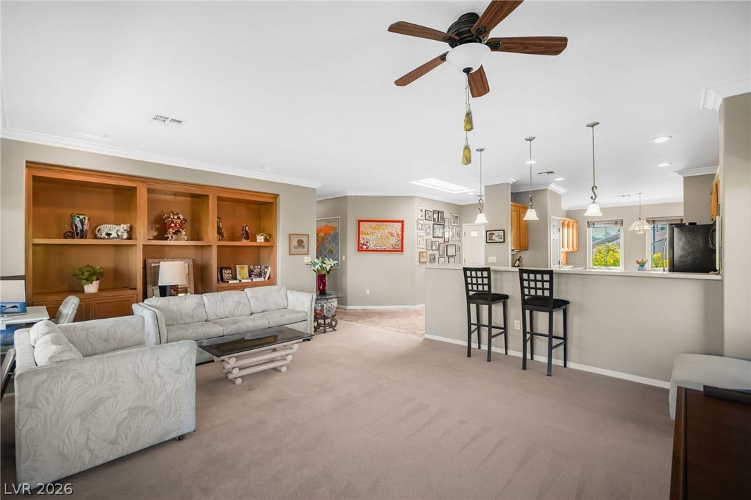 2738 Grand Forks Road, Henderson, NV 89052 Crown molding and an open-concept layout define this living space connected to the kitchen.