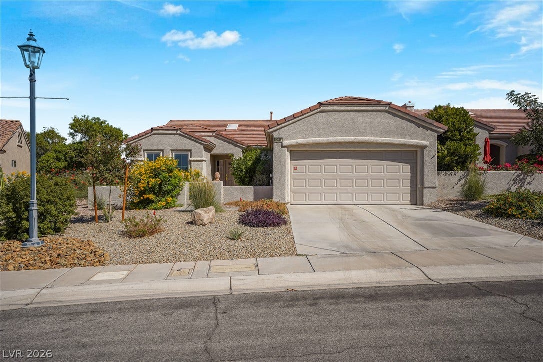 2738 Grand Forks Road, Henderson, NV 89052 Desert landscaping and a paved driveway complement this classic stucco exterior.
