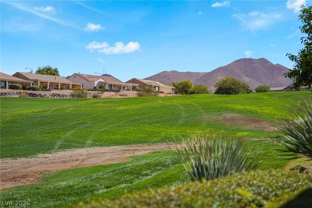 2738 Grand Forks Road, Henderson, NV 89052 Rolling fairways extend toward rugged mountain ridges under clear desert skies.