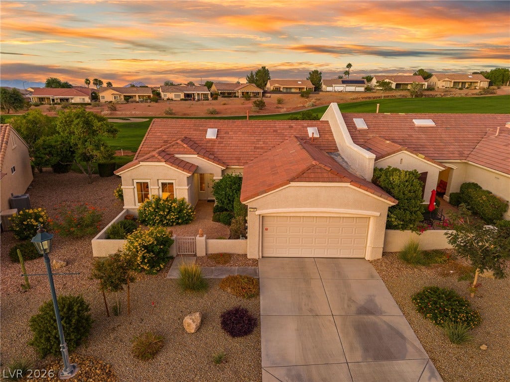 2738 Grand Forks Road, Henderson, NV 89052 Desert landscaping and a tiled roof complement this classic single-story home bordering a golf course.