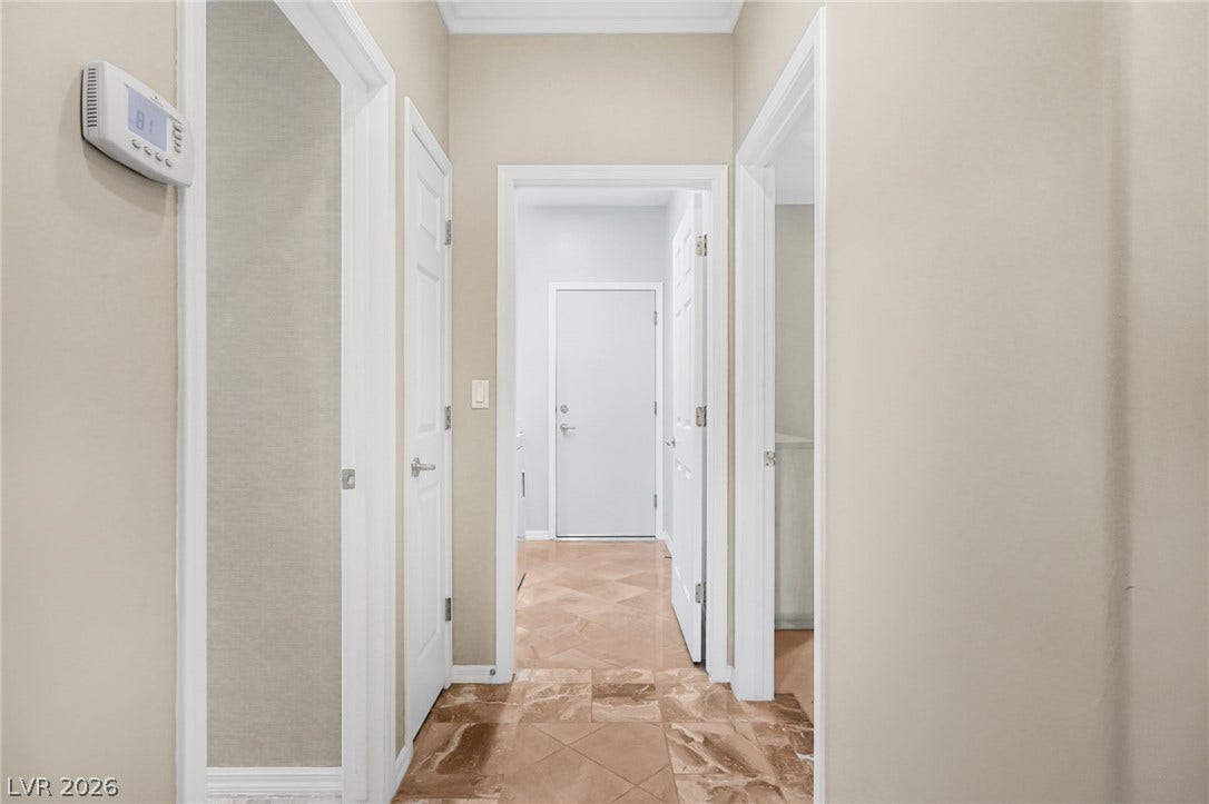 2738 Grand Forks Road, Henderson, NV 89052 Gleaming tile floors guide the way through a central hallway connecting multiple living spaces.