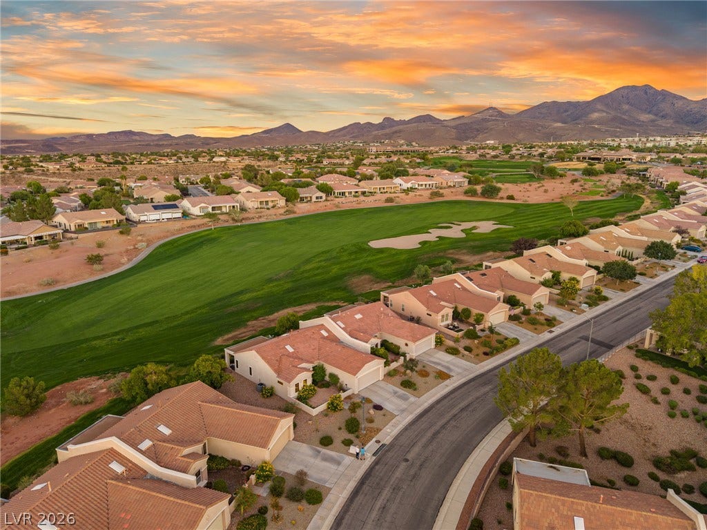 2738 Grand Forks Road, Henderson, NV 89052 An aerial view showcases a peaceful neighborhood winding alongside a lush green golf course.
