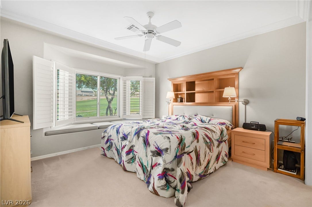 2738 Grand Forks Road, Henderson, NV 89052 A spacious bedroom features a built-in window seat and detailed crown molding.