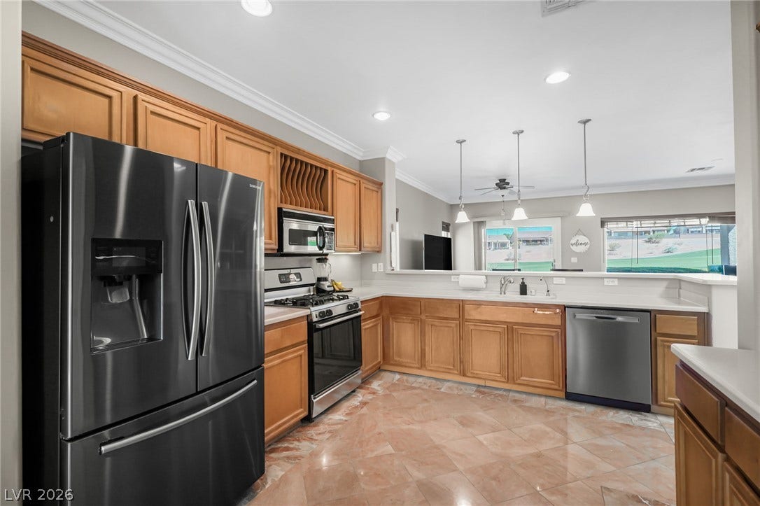 2738 Grand Forks Road, Henderson, NV 89052 Polished tile flooring and traditional wood cabinetry anchor this functional cooking space.