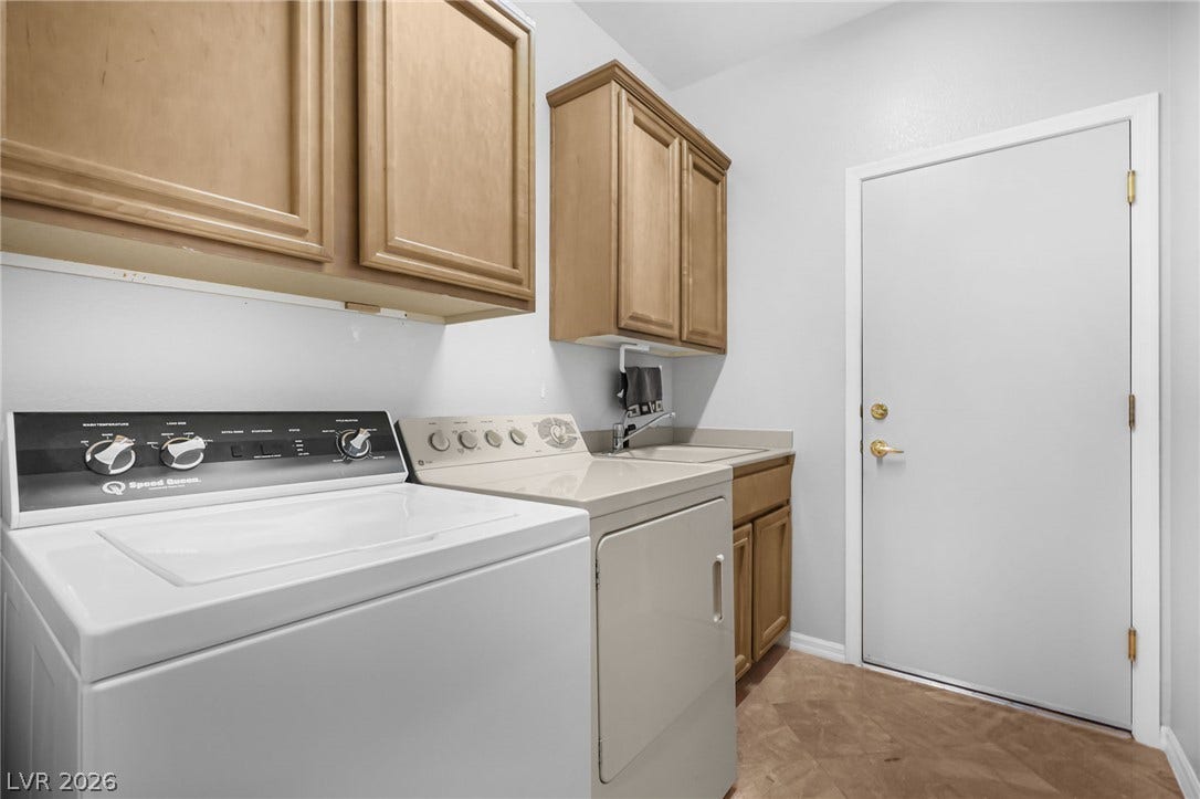 2738 Grand Forks Road, Henderson, NV 89052 A functional laundry area includes built-in cabinetry and durable tiled flooring.