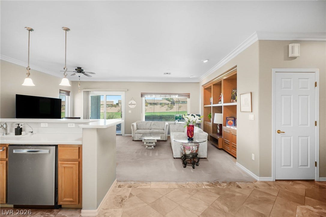 2738 Grand Forks Road, Henderson, NV 89052 An open floorplan seamlessly connects the tiled kitchen entry to a carpeted living space.