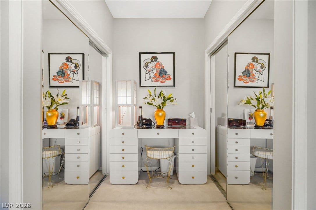 2738 Grand Forks Road, Henderson, NV 89052 Mirrored sliding doors flank a built-in dressing vanity area with clean architectural lines.