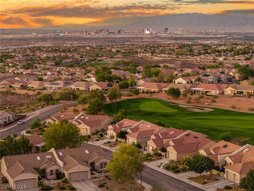2738 Grand Forks Road, Henderson, NV 89052 Sweeping views across a golf course green toward the distant city skyline under sunset skies.