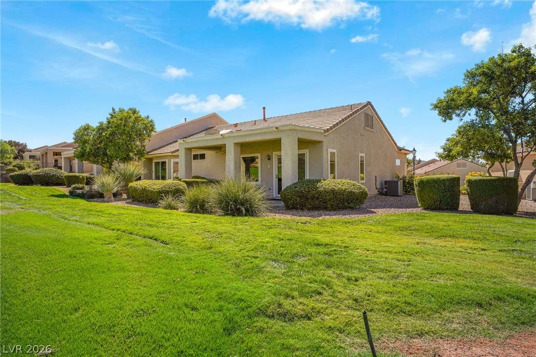 2738 Grand Forks Road, Henderson, NV 89052 A spacious green lawn borders the covered patio of this classic stucco home.