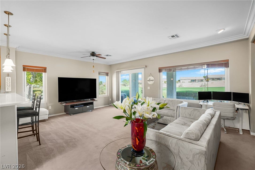 2738 Grand Forks Road, Henderson, NV 89052 Generous windows frame scenic golf course views in this open-concept main living area.
