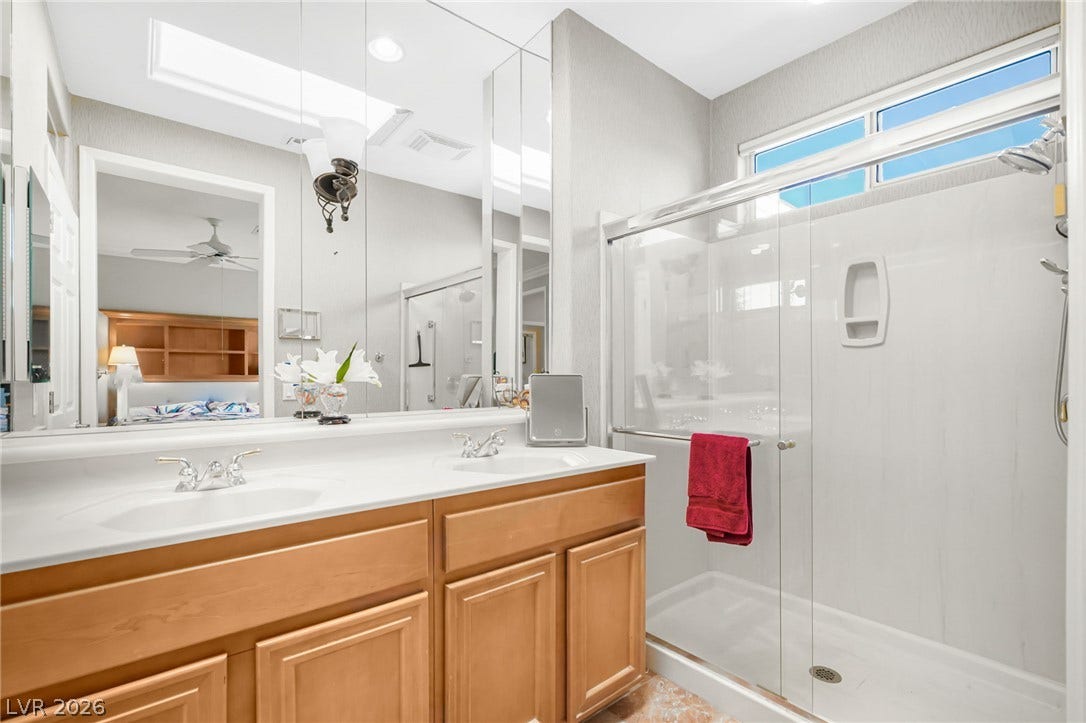 2738 Grand Forks Road, Henderson, NV 89052 Double vanities and a glass-enclosed shower highlight this pristine primary bath design.
