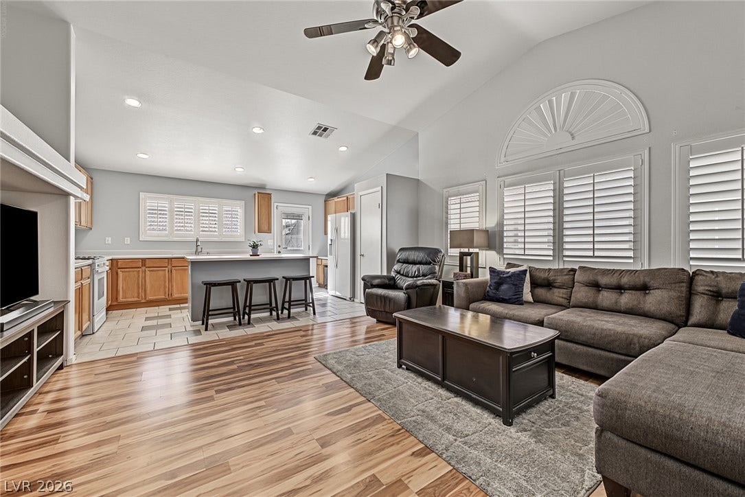 629 Lava Beds Way, North Las Vegas, NV 89084 Soaring vaulted ceilings and polished hardwood flooring elevate this inviting, open-concept living space.