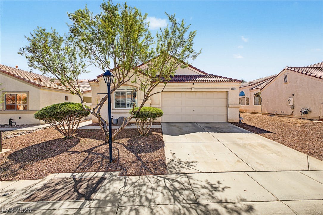 629 Lava Beds Way, North Las Vegas, NV 89084 Low-maintenance desert landscaping frames a stucco exterior with a tiled roof and attached garage.