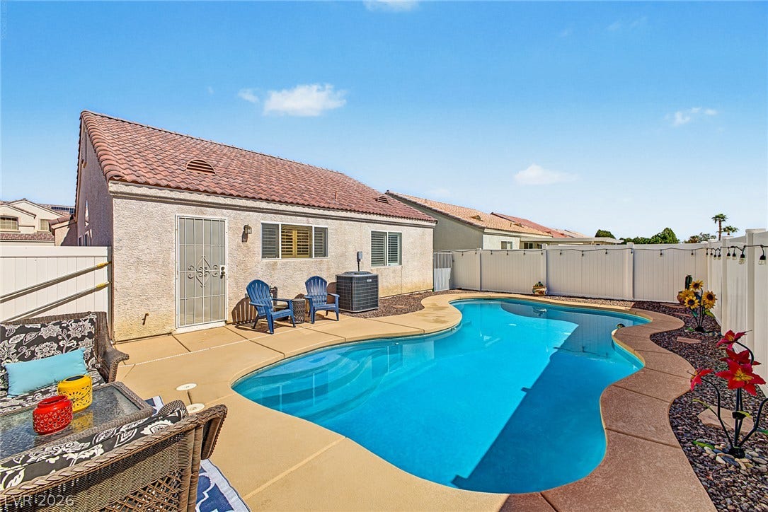 629 Lava Beds Way, North Las Vegas, NV 89084 An inviting swimming pool and concrete patio highlight this private backyard setting.