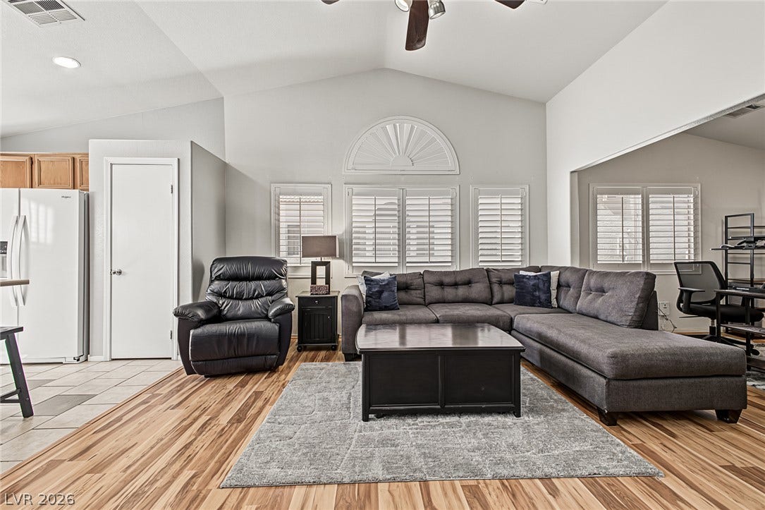 629 Lava Beds Way, North Las Vegas, NV 89084 Soaring vaulted ceilings and rich wood-style flooring anchor this open-concept main living area.
