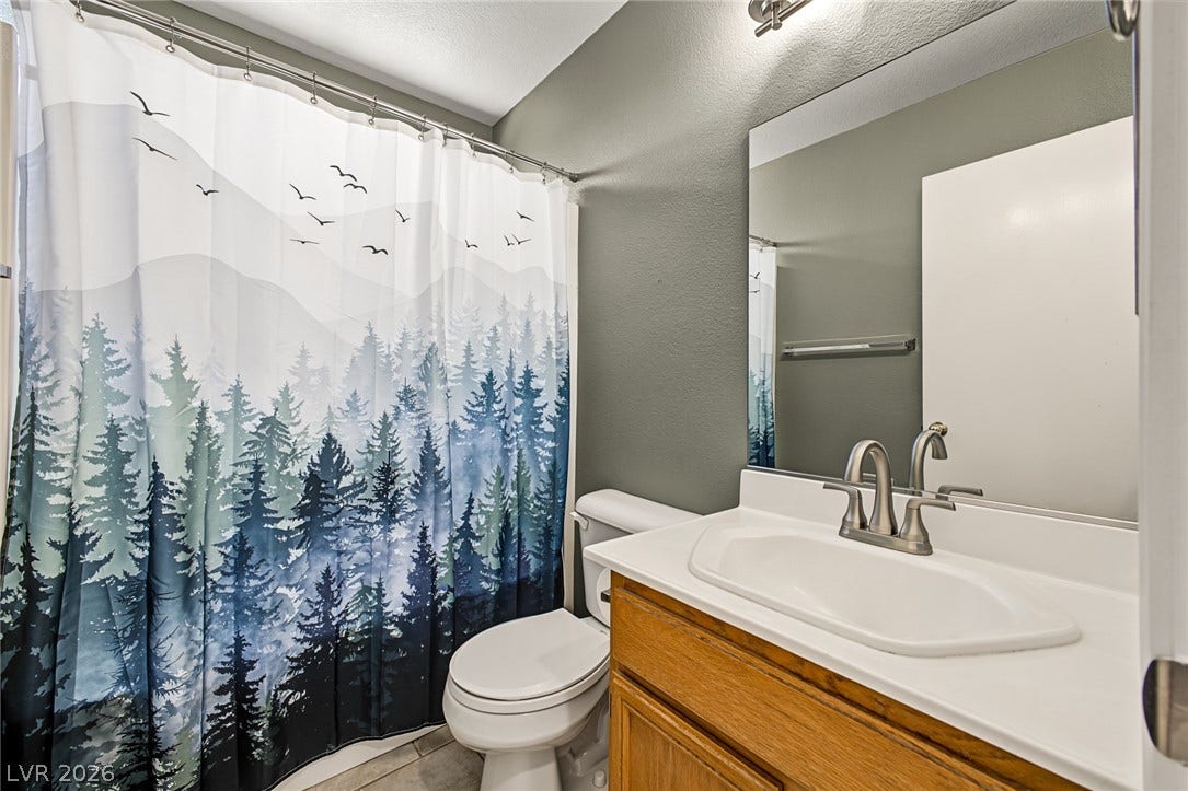 629 Lava Beds Way, North Las Vegas, NV 89084 A classic wood vanity and integrated sink bring clean lines to this updated bathroom.