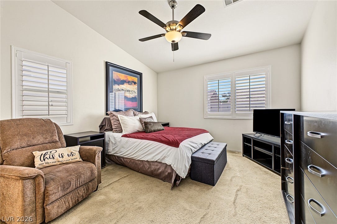 629 Lava Beds Way, North Las Vegas, NV 89084 Vaulted ceilings and plantation shutters elevate this comfortable bedroom space.