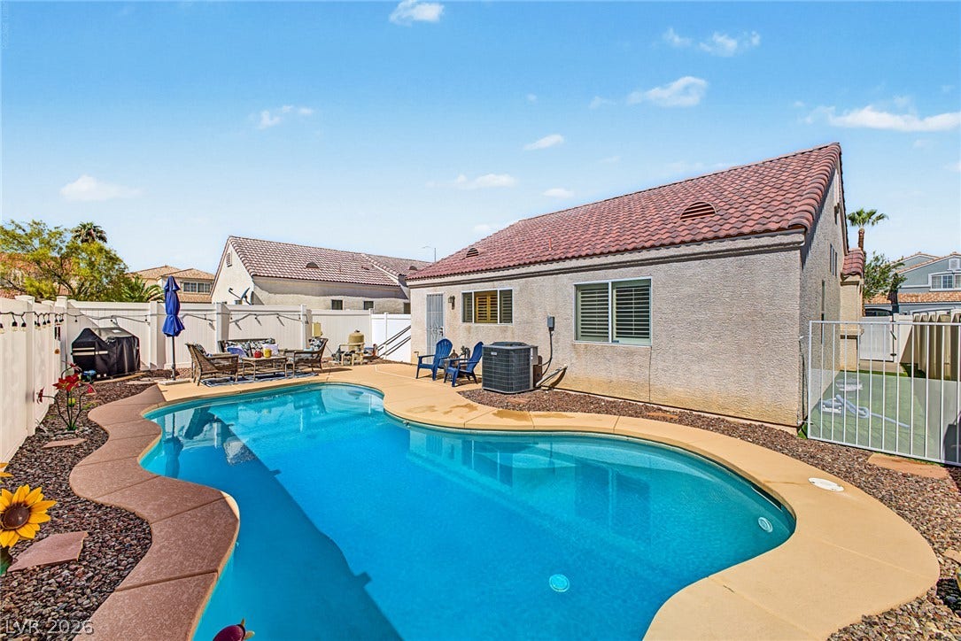 629 Lava Beds Way, North Las Vegas, NV 89084 A private swimming pool highlights this backyard oasis framed by tiled rooflines and desert landscaping.