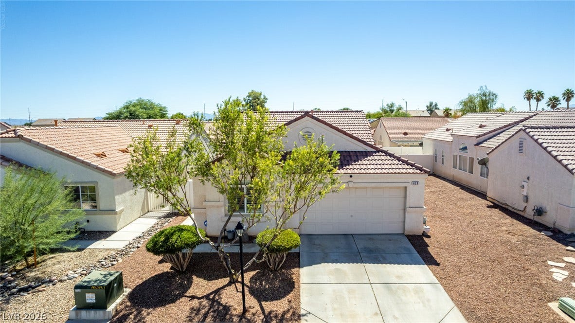 629 Lava Beds Way, North Las Vegas, NV 89084 Spanish tile roofs and stucco exteriors define this desert-landscaped residential neighborhood.