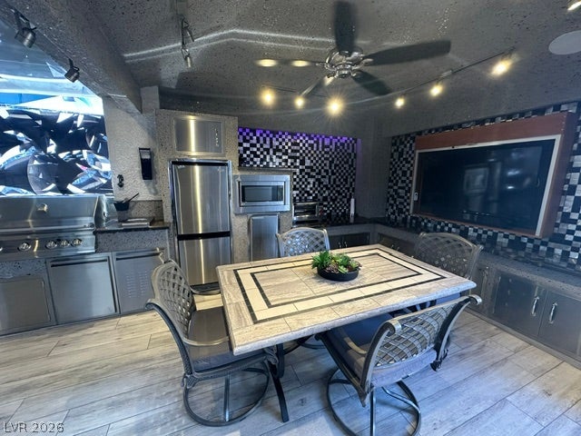 8175 Arville Street, #400, Las Vegas, NV 89139 An covered patio showcases a fully equipped outdoor kitchen and durable tile flooring.