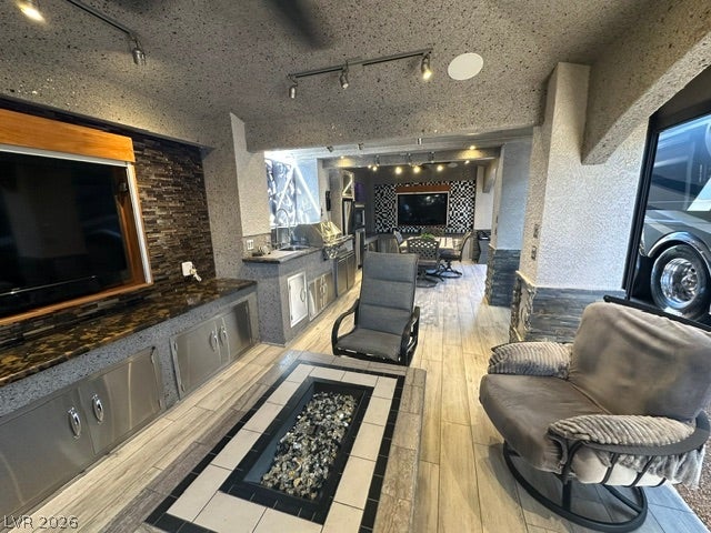 8175 Arville Street, #400, Las Vegas, NV 89139 An inviting outdoor living area includes a built-in fire pit and a fully equipped kitchen.