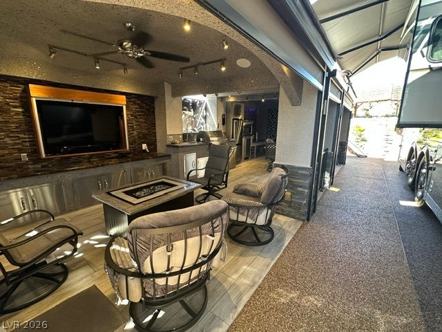 8175 Arville Street, #400, Las Vegas, NV 89139 An outdoor entertainment space connects to a modern kitchen with built-in cabinetry and stone accents.