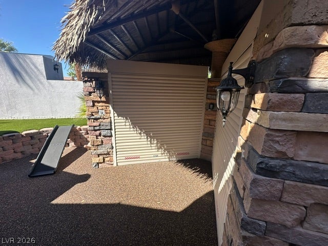 8175 Arville Street, #400, Las Vegas, NV 89139 A covered outdoor area features textured stone pillars and a thatched pavilion structure.