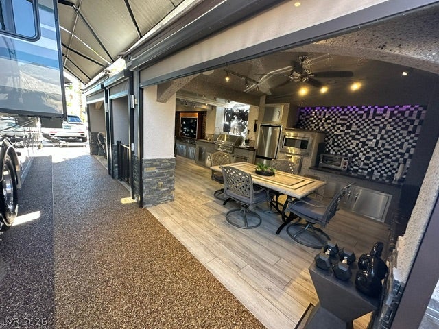 8175 Arville Street, #400, Las Vegas, NV 89139 An outdoor kitchen features modern tile flooring alongside a covered driveway.