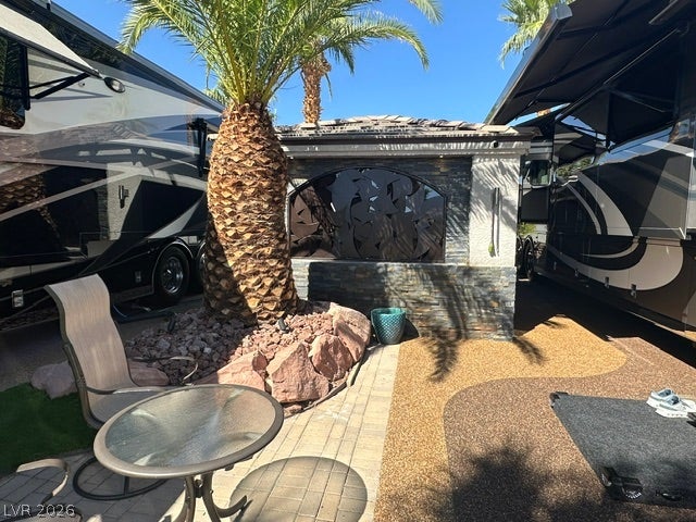 8175 Arville Street, #400, Las Vegas, NV 89139 Palm trees shade a paved patio setting framed by structured stone accents.