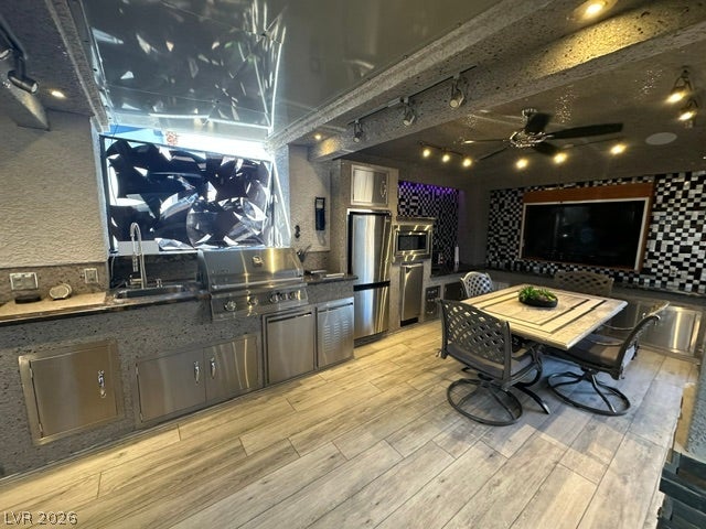 8175 Arville Street, #400, Las Vegas, NV 89139 Industrial finishes and wood-look tile flooring define this modern indoor cooking and dining space.