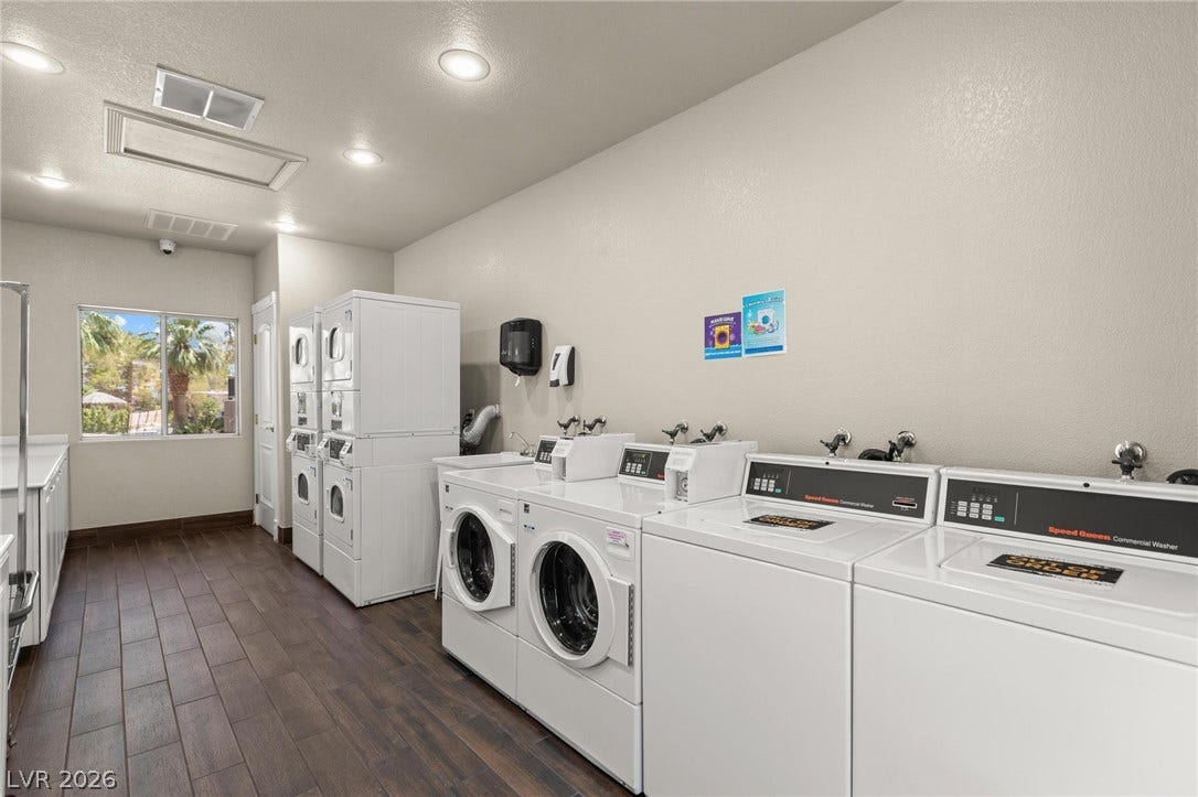 8175 Arville Street, #400, Las Vegas, NV 89139 Recessed lighting illuminates this functional laundry room lined with wood-look tile flooring.