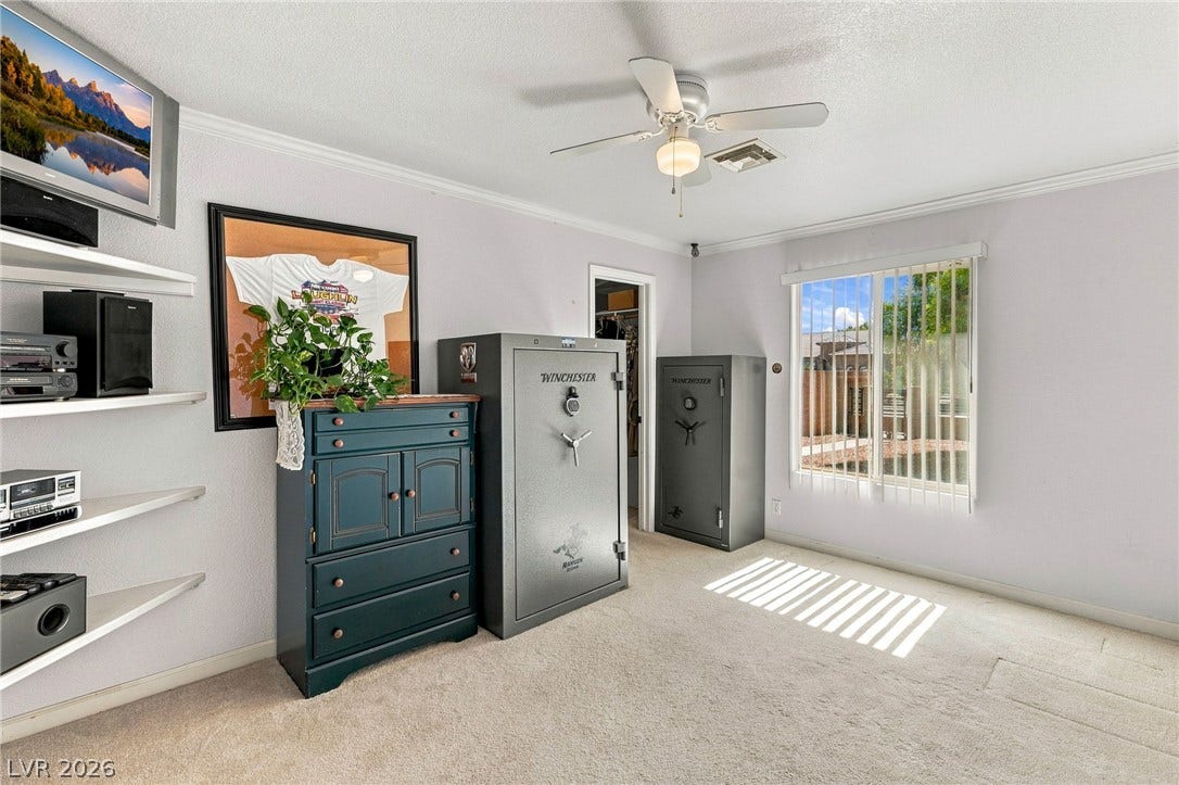 6560 Whispering Sands Drive, Las Vegas, NV 89131 Carpeted flooring and crown molding frame this versatile secondary room.