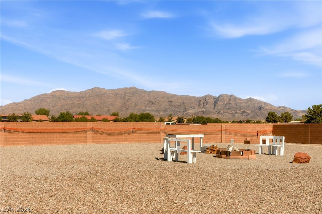 6560 Whispering Sands Drive, Las Vegas, NV 89131 An expansive gravel yard offers sweeping views of the majestic desert mountains.
