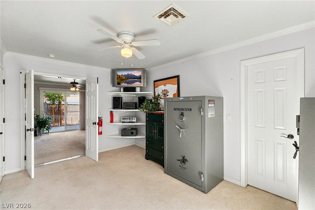 6560 Whispering Sands Drive, Las Vegas, NV 89131 Double doors open into a versatile bonus space featuring plush carpeting and crown molding.