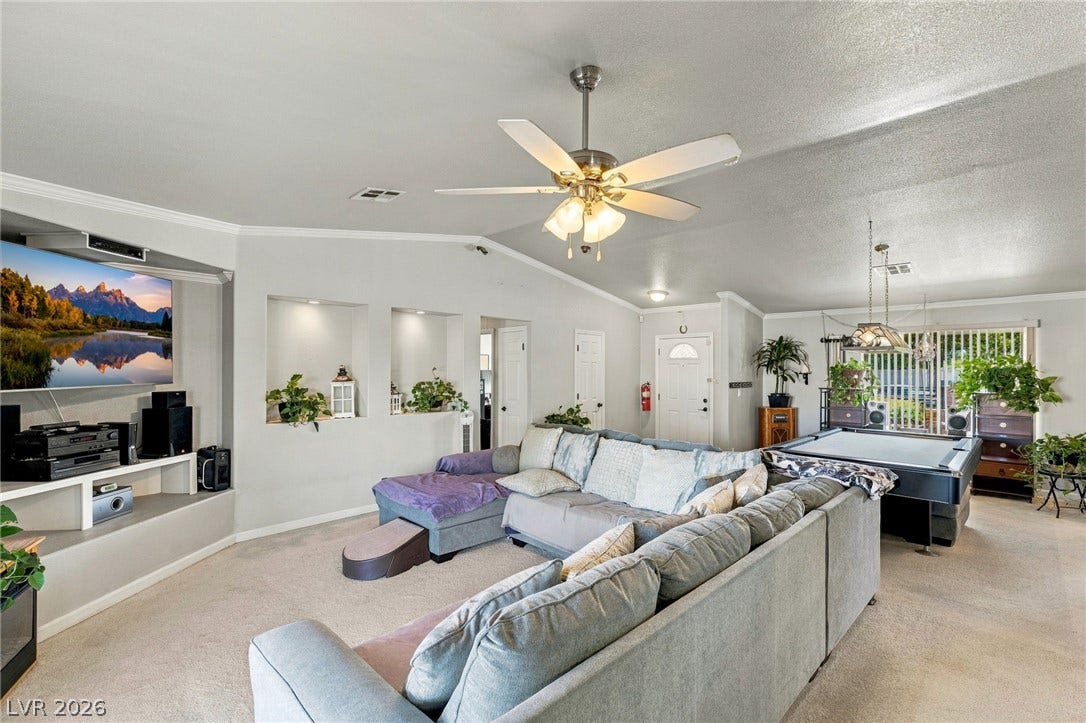 6560 Whispering Sands Drive, Las Vegas, NV 89131 An open floorplan design connects this comfortable living space seamlessly to adjacent recreational areas.
