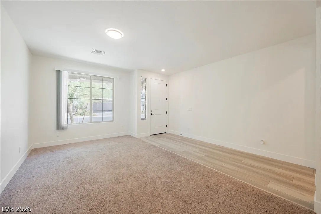 8683 S Black Cordon Road, Las Vegas, NV 89139 Gleaming wood-look flooring transitions seamlessly to plush carpeting in this welcoming entryway.